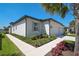 Beautiful home with a well-manicured lawn, mature landscaping, and a two-car garage at 8553 Whispering St, Sarasota, FL 34240