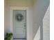 Stylish front door adorned with a wreath, creating a warm welcome to this inviting home at 8553 Whispering St, Sarasota, FL 34240