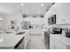 Well-lit kitchen features stainless steel appliances, white cabinets, and quartz countertops at 8553 Whispering St, Sarasota, FL 34240