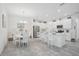 Open kitchen features white cabinets, stainless steel appliances, and a breakfast bar at 8553 Whispering St, Sarasota, FL 34240