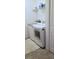 Functional laundry room with a washer, dryer, and storage shelf at 8553 Whispering St, Sarasota, FL 34240