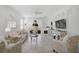 Bright living room with a decorative fireplace, neutral furnishings and large windows at 8553 Whispering St, Sarasota, FL 34240