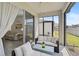 Screened patio features comfortable seating and a view of the backyard at 8553 Whispering St, Sarasota, FL 34240