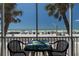 Relaxing balcony with seating, featuring views of the beach and palm trees at 901 Gulf S Dr # 3, Bradenton Beach, FL 34217