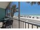 Charming balcony view overlooking the beach, palm trees, and ocean at 901 Gulf S Dr # 3, Bradenton Beach, FL 34217