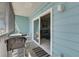 Cozy balcony with seating leading to a living room with sliding doors at 901 Gulf S Dr # 3, Bradenton Beach, FL 34217