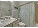 Well-lit bathroom features a vanity with marble countertop and shower with starfish curtain at 901 Gulf S Dr # 3, Bradenton Beach, FL 34217