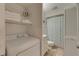 Bright bathroom featuring a washer/dryer, storage shelves, and tiled floors at 901 Gulf S Dr # 3, Bradenton Beach, FL 34217