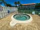 Close-up of the hot tub within the community pool area, surrounded by brick pavers at 901 Gulf S Dr # 3, Bradenton Beach, FL 34217