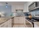 Well-lit kitchen featuring granite countertops, stainless appliances, and white cabinetry at 901 Gulf S Dr # 3, Bradenton Beach, FL 34217