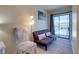 Comfortable living area features a futon, accent chair, and a balcony for relaxed living at 901 Gulf S Dr # 3, Bradenton Beach, FL 34217