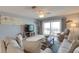 Inviting living room with TV, comfortable seating, and scenic ocean views from balcony at 901 Gulf S Dr # 3, Bradenton Beach, FL 34217