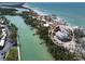 Aerial view of waterfront home, surrounded by tropical greenery and a serene waterway, provides privacy and scenic views at 9265 Blind Pass Rd, Sarasota, FL 34242
