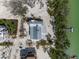 Aerial view of a luxury waterfront house surrounded by lush landscape and private beach at 9265 Blind Pass Rd, Sarasota, FL 34242