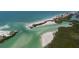 Ariel view of a coastal island and inlet, showing beaches, vegetation, and clear waters at 9265 Blind Pass Rd, Sarasota, FL 34242
