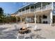 Charming backyard features a cozy fire pit area with Adirondack chairs, ideal for outdoor relaxation and entertaining at 9265 Blind Pass Rd, Sarasota, FL 34242