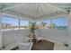 Relaxing balcony featuring comfortable white Adirondack chairs and a stunning ocean view at 9265 Blind Pass Rd, Sarasota, FL 34242