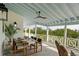 Spacious outdoor balcony with dining set, ceiling fan, and beautiful scenery at 9265 Blind Pass Rd, Sarasota, FL 34242