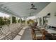 Spacious outdoor balcony with comfortable seating for dining, overlooking beautiful natural scenery at 9265 Blind Pass Rd, Sarasota, FL 34242