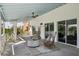 Outdoor balcony with comfortable rattan chairs, a ceiling fan, and a relaxing space at 9265 Blind Pass Rd, Sarasota, FL 34242