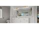 Bright bathroom featuring a double vanity, modern fixtures, and a large mirror reflecting natural light at 9265 Blind Pass Rd, Sarasota, FL 34242