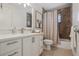 Well-lit bathroom featuring marble tile and shower, a modern vanity, and elegant fixtures at 9265 Blind Pass Rd, Sarasota, FL 34242