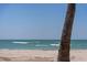Coastal beach scene with a view of gentle waves and a serene shoreline at 9265 Blind Pass Rd, Sarasota, FL 34242