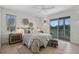 Comfortable bedroom featuring neutral tones, soft textures, and a private balcony with scenic outdoor views at 9265 Blind Pass Rd, Sarasota, FL 34242