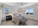 Cozy bedroom with a plush bed, modern decor, and plenty of natural light from the large windows at 9265 Blind Pass Rd, Sarasota, FL 34242