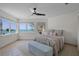 Calm, serene bedroom with an ocean view window, ceiling fan, and plush accents for ultimate relaxation at 9265 Blind Pass Rd, Sarasota, FL 34242