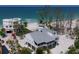 Beautiful beachside home with a metal roof offers stunning ocean views and features a wraparound porch at 9265 Blind Pass Rd, Sarasota, FL 34242