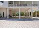 Underneath view of a coastal home on stilts with white columns and sandy ground at 9265 Blind Pass Rd, Sarasota, FL 34242