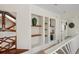 Bright hallway featuring built in niches and shelves with decorative vases at 9265 Blind Pass Rd, Sarasota, FL 34242