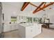Open kitchen with white cabinets, stainless steel appliances, center island, and seamless transition to outdoor spaces at 9265 Blind Pass Rd, Sarasota, FL 34242