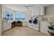 Bright laundry room with built-in desk, cabinets, and ocean view, ideal for multi-tasking at 9265 Blind Pass Rd, Sarasota, FL 34242