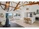 Bright, open living area with exposed beams, ocean view, and modern kitchen featuring stainless steel appliances at 9265 Blind Pass Rd, Sarasota, FL 34242