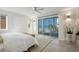 Serene main bedroom with private balcony, ocean view and neutral tones, perfect for relaxation at 9265 Blind Pass Rd, Sarasota, FL 34242
