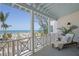 Inviting porch featuring a daybed and ocean view, perfect for relaxation and enjoying the coastal breeze at 9265 Blind Pass Rd, Sarasota, FL 34242
