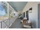 Inviting porch with comfortable seating, and ocean view, perfect for relaxation and enjoying the coastal breeze at 9265 Blind Pass Rd, Sarasota, FL 34242