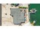 Aerial view of waterfront home with boat dock and patio areas at 10008 Spoonbill E Rd, Bradenton, FL 34209