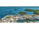 Bird's eye view of waterfront homes with boat docks, lush landscaping, and picturesque water views at 10008 Spoonbill E Rd, Bradenton, FL 34209