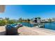 Beautiful waterfront backyard featuring a patio with comfortable seating and a private boat dock at 10008 Spoonbill E Rd, Bradenton, FL 34209