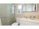 Bathroom featuring a shower, toilet, sink, and mirrored medicine cabinet at 10008 Spoonbill E Rd, Bradenton, FL 34209
