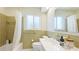Bathroom featuring a bathtub with shower, toilet, sink, and window at 10008 Spoonbill E Rd, Bradenton, FL 34209