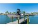 Dock featuring a boat lift in a scenic waterfront community at 10008 Spoonbill E Rd, Bradenton, FL 34209
