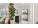 Charming entryway with a decorative cabinet, round mirror, and a view of the outdoor greenery at 10008 Spoonbill E Rd, Bradenton, FL 34209