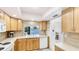 Well-lit kitchen with warm wood cabinetry, modern appliances, and a view of the water at 10008 Spoonbill E Rd, Bradenton, FL 34209