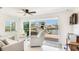 Bright living room with sliding doors offering waterfront views and access to the private dock at 10008 Spoonbill E Rd, Bradenton, FL 34209