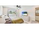 Bright bedroom featuring a waterfront view, ceiling fan and a TV at 10008 Spoonbill E Rd, Bradenton, FL 34209