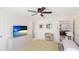 Bedroom with views to the living room, with a TV, ceiling fan and decorations at 10008 Spoonbill E Rd, Bradenton, FL 34209